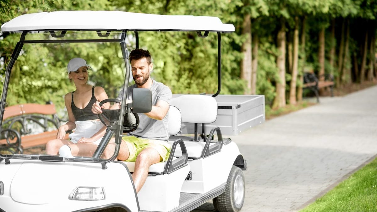 couple on golf cart